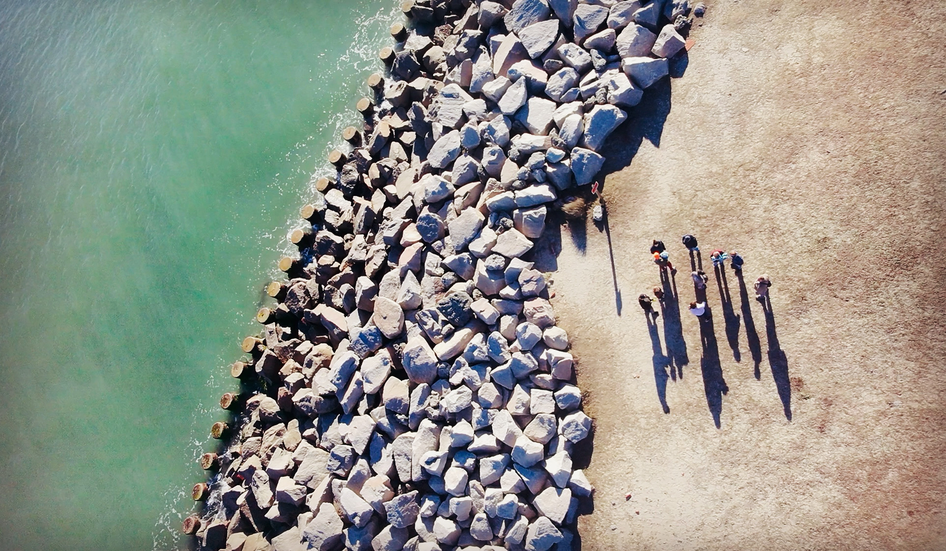 Overhead aerial view of shoreline and people